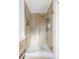 Modern bathroom shower featuring glass door, gold hardware and shelf at 417 S Pontiac Way, Denver, CO 80210