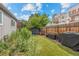 Landscaped backyard with artificial turf, seating area, and a grill at 1217 Osceola St, Denver, CO 80204