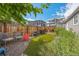 Secluded backyard featuring a green lawn, an outdoor grill, and comfortable seating at 1217 Osceola St, Denver, CO 80204