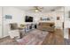 Comfortable living room featuring a plush sofa, a modern television, and stylish decor on hardwood floors at 1217 Osceola St, Denver, CO 80204