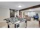 Finished basement with a foosball table, open layout, and exposed beams, creating a versatile entertainment space at 2918 W 135Th Pl, Thornton, CO 80241