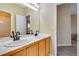 Bathroom features double sinks, tile countertops and a large mirror with light fixtures at 2918 W 135Th Pl, Thornton, CO 80241