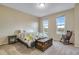 Bedroom with a bed and rocking chair, two windows, and an antique trunk for storage at 2918 W 135Th Pl, Thornton, CO 80241