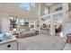 Open-concept living room with high ceilings, large windows, and seamless flow to the kitchen and dining areas at 2918 W 135Th Pl, Thornton, CO 80241