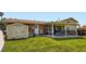Backyard featuring a shed, covered patio and a spacious green lawn at 6212 S Ash W Cir, Centennial, CO 80121