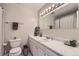 Well-lit bathroom with a white vanity, toilet, and shower at 6212 S Ash W Cir, Centennial, CO 80121