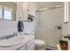 Clean bathroom with white tile, a glass-enclosed shower, and classic fixtures at 6212 S Ash W Cir, Centennial, CO 80121