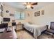 Cozy bedroom with a ceiling fan, a desk, and neutral decor at 6212 S Ash W Cir, Centennial, CO 80121