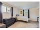 Comfortable bedroom with black dresser and natural light from two windows at 6212 S Ash W Cir, Centennial, CO 80121