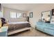 Bright bedroom featuring a white bed frame and a charming, light blue dresser at 6212 S Ash W Cir, Centennial, CO 80121