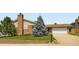 Charming home with brick and siding, a well-kept lawn, and a mature tree enhancing curb appeal at 6212 S Ash W Cir, Centennial, CO 80121