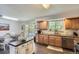Inviting kitchen with wooden cabinets, stainless steel appliances, and an island with patio door access at 6212 S Ash W Cir, Centennial, CO 80121