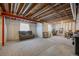 Unfinished basement area with exposed ceiling, carpet, small windows, and potential for customization at 22062 E Irish Dr, Aurora, CO 80016