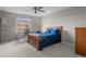 Cozy bedroom featuring a ceiling fan, a large window, and a well-coordinated decor at 22062 E Irish Dr, Aurora, CO 80016