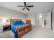 A comfortable bedroom with carpet, ceiling fan and a view to the en-suite bathroom at 22062 E Irish Dr, Aurora, CO 80016