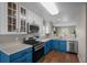 Bright kitchen with stainless steel appliances, blue cabinets, and new light fixture at 22062 E Irish Dr, Aurora, CO 80016