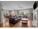 Open concept living room featuring hardwood floors, fireplace, and a dining area at 22062 E Irish Dr, Aurora, CO 80016