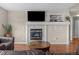 Relaxing living room with fireplace, mounted TV, and neutral décor at 22062 E Irish Dr, Aurora, CO 80016