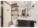 Nicely decorated bathroom with a glass-door shower, open shelving, and a modern vanity at 2165 Summerlin Ln, Longmont, CO 80503