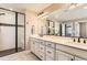 Well-lit bathroom featuring granite countertops, dual sinks, and a glass-enclosed shower at 2165 Summerlin Ln, Longmont, CO 80503