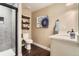 Bathroom with a glass door shower, floating shelves, and sleek, dark wood-look flooring at 2165 Summerlin Ln, Longmont, CO 80503