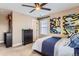 Comfortable bedroom with bright abstract art, and a ceiling fan for a light and airy atmosphere at 2165 Summerlin Ln, Longmont, CO 80503