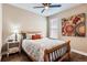 Cozy bedroom with hardwood floors, wooden bed frame, and bright, colorful wall decor at 2165 Summerlin Ln, Longmont, CO 80503