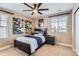 Bedroom with modern decor, window light, and dark bed frame with bright, colorful artwork at 2165 Summerlin Ln, Longmont, CO 80503