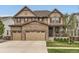 Charming two-story home with stone accents, a three-car garage, and a covered front porch at 2165 Summerlin Ln, Longmont, CO 80503