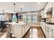 Bright kitchen features a large island with seating, quartz countertops, and stainless steel appliances at 2165 Summerlin Ln, Longmont, CO 80503