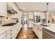 Well-equipped kitchen with stainless appliances, tile backsplash, and access to a dining area at 2165 Summerlin Ln, Longmont, CO 80503