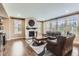 Bright living room featuring a fireplace, hardwood floors, and large windows with neighborhood views at 2165 Summerlin Ln, Longmont, CO 80503