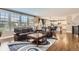 Open-concept living room with hardwood floors, large windows, and seamless transition to modern kitchen at 2165 Summerlin Ln, Longmont, CO 80503