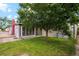 Well maintained backyard with a large tree shading the manicured lawn at 5445 Reed Ct, Arvada, CO 80002