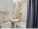 Cozy bathroom with a shower-tub combo, tiled walls, and modern fixtures at 5445 Reed Ct, Arvada, CO 80002