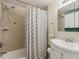 Clean and simple bathroom featuring a shower and tub combination, along with a bright vanity at 5445 Reed Ct, Arvada, CO 80002