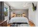 Bright bedroom has hardwood floors, a ceiling fan and soft modern lighting with plenty of natural light at 5445 Reed Ct, Arvada, CO 80002