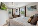 This bedroom offers great light, hardwood floors and a neutral color palette for a serene atmosphere at 5445 Reed Ct, Arvada, CO 80002