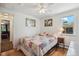 Cozy bedroom features a comfortable bed, wood floors and a ceiling fan with ample light from the window at 5445 Reed Ct, Arvada, CO 80002