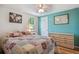 Inviting bedroom featuring a bright color accent wall, natural light, and hardwood floors at 5445 Reed Ct, Arvada, CO 80002