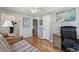 Bedroom featuring hardwood floors, neutral walls, ceiling fan, and view of an adjacent bathroom at 5445 Reed Ct, Arvada, CO 80002