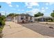 Cozy single-story home with a detached garage and well-kept landscaping, on a sunny day at 5445 Reed Ct, Arvada, CO 80002