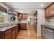 Charming kitchen boasting wood floors, ample storage, and granite countertops with stainless steel appliances at 5445 Reed Ct, Arvada, CO 80002