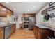 Spacious kitchen featuring stainless steel appliances, tiled backsplash, and beautiful granite countertops at 5445 Reed Ct, Arvada, CO 80002