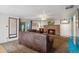 Comfortable living room with a brick fireplace, ceiling fan, and a sliding glass door to the backyard at 5445 Reed Ct, Arvada, CO 80002