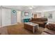 Inviting living room with neutral walls, carpeted floor, and a view into the dining area at 5445 Reed Ct, Arvada, CO 80002