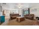 Open-concept living room with comfortable seating, a view into the kitchen, and sliding doors at 5445 Reed Ct, Arvada, CO 80002