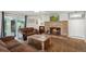 Living room with brick fireplace and media, comfortable seating, and natural lighting at 5445 Reed Ct, Arvada, CO 80002