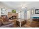 Cozy living room featuring a brick fireplace, comfortable seating, and neutral walls at 5445 Reed Ct, Arvada, CO 80002