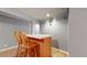 Basement bar with wooden bar and 2 chairs at 2266 S Kenton St, Aurora, CO 80014